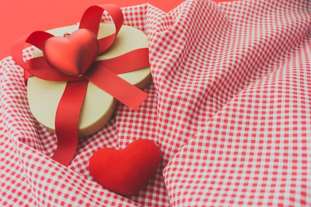 Red box with a red bow on a cloth