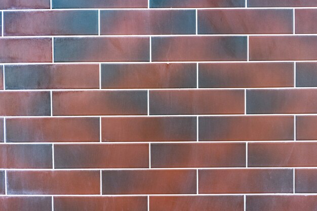 Red brick wall. Texture of dark brown and red brick with white filling