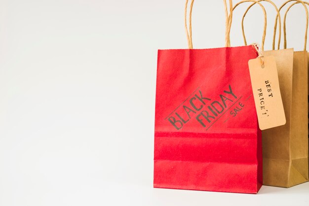 Red and brown paper shopping bags with sale tag