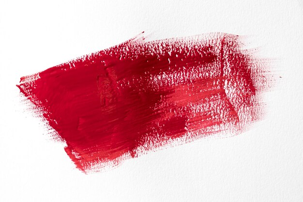 Red brush stroke on white background