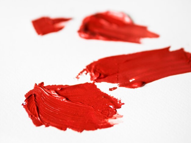 Red brush strokes on canvas