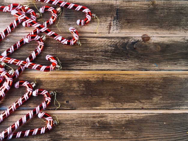 Free photo red candy canes on wooden table