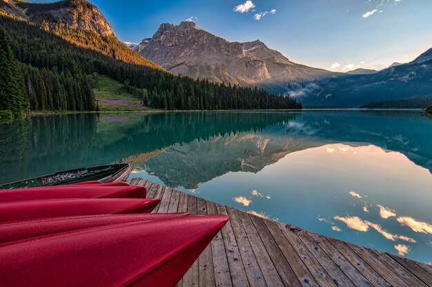 Red Canoes on Sea Dock Near Calm Body of Water