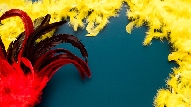 Red carnival mask on blue background with copy space