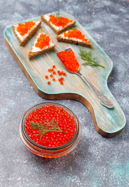 Red caviar in glass bowl and in a spoon