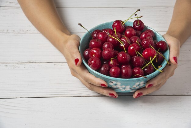 Red cherries in a decorative blue bowl