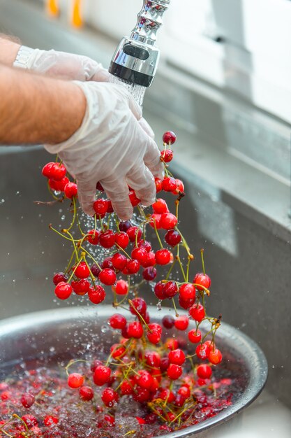 Red cherries washing in the water