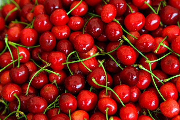 Red cherries with green stems, top view