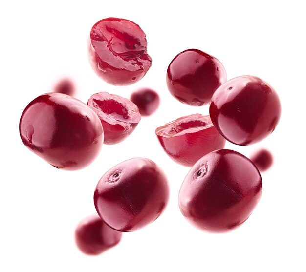 Red cherry berries levitate on a white background