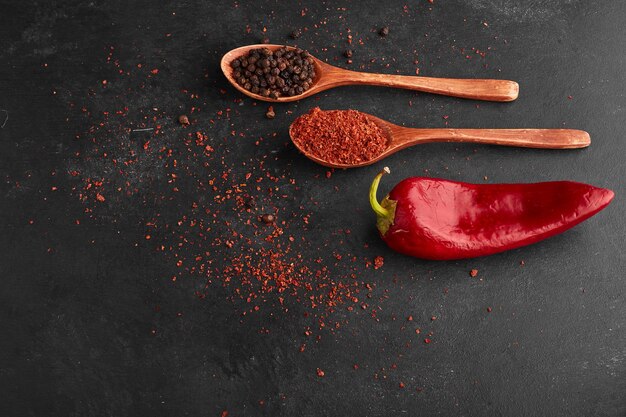 Red chili pepper with paprika in a wooden spoon. 