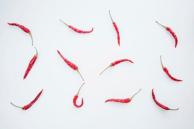 Free photo red chilies arranged on white background