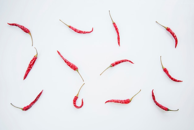Red chilies arranged on white background