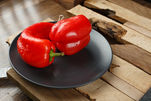 Red chilies in a black ceramic plate.