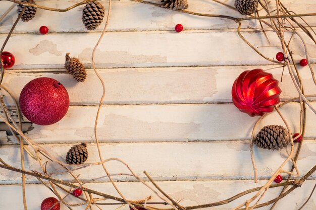 Red christmas ball with branches making a circle