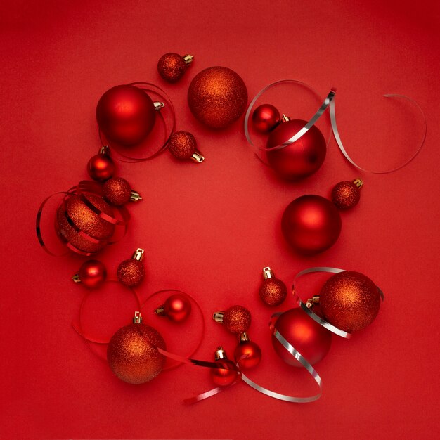 Red Christmas balls wreath on red table