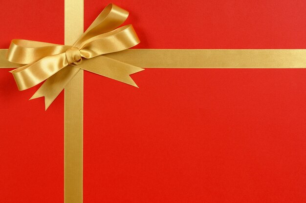 Red christmas gift with a elegant golden bow 