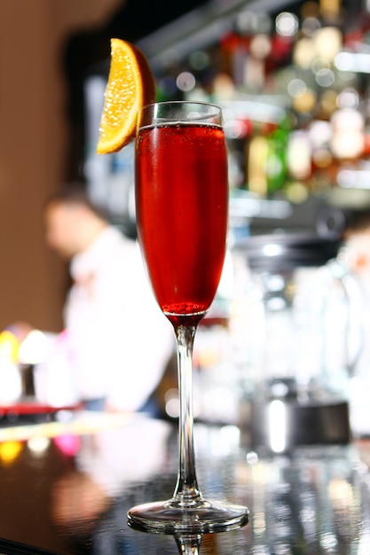 Red cocktail in a champagne glass 