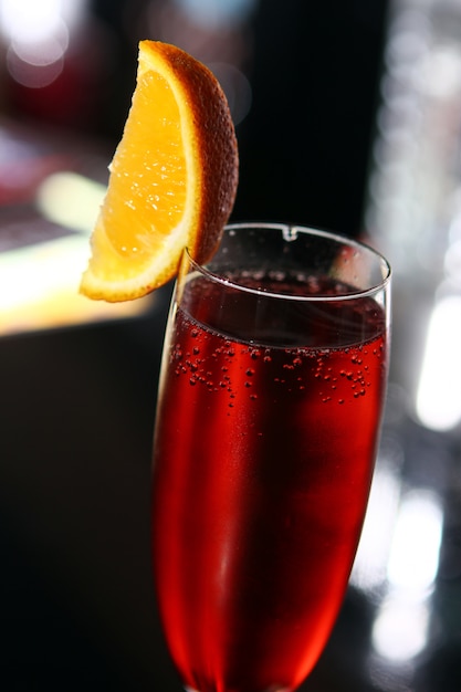 Red cocktail in a champagne glass 