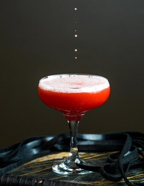 Red cocktail with foam