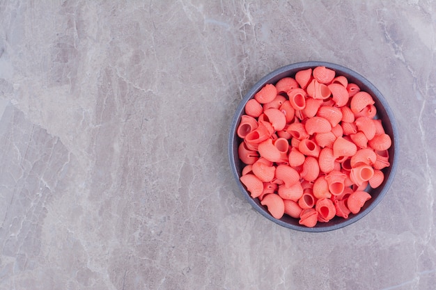 Red color pastas in a black metallic pan