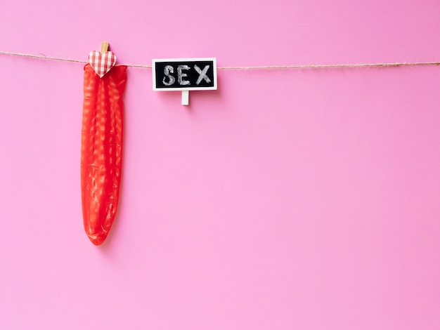 Red condom hanging on clothesline