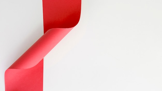 Red curled ribbon against white backdrop