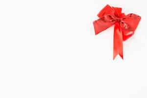 Free photo red decorative bow on the corner of white background