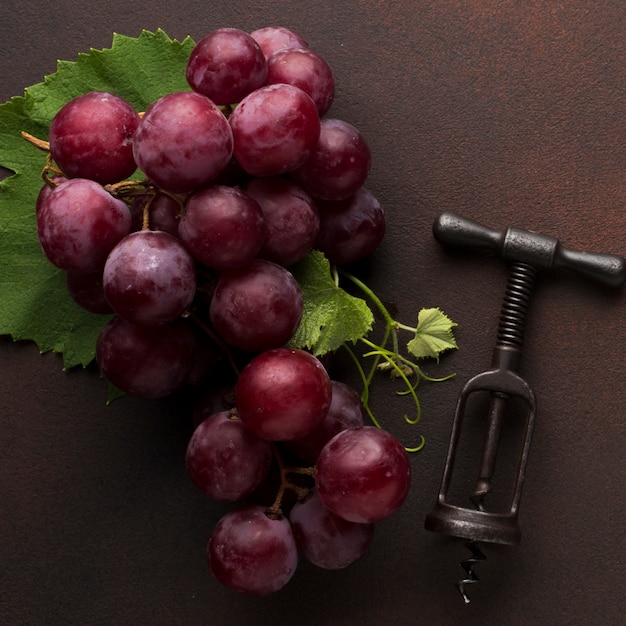 Red delicious grapes and corkscrew