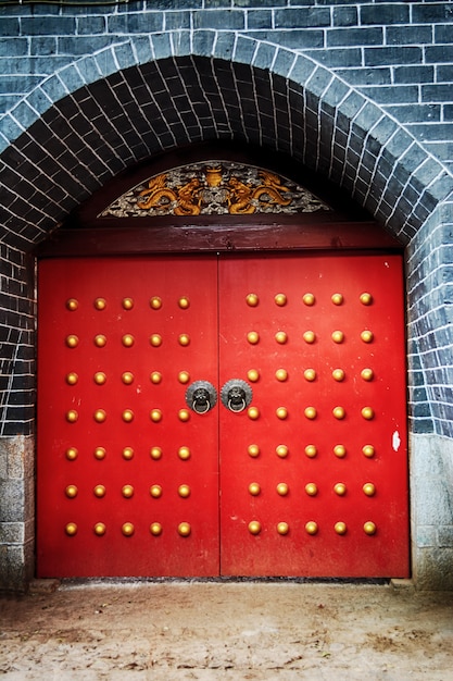 Free photo red door with gold button decoration