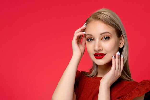 Red dress close up cute classy pretty lady in burgundy dress with red lipstick touching face