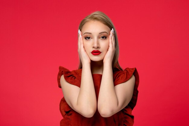 Red dress cute classy adorable girl in burgundy dress with red lipstick touching face from both sides