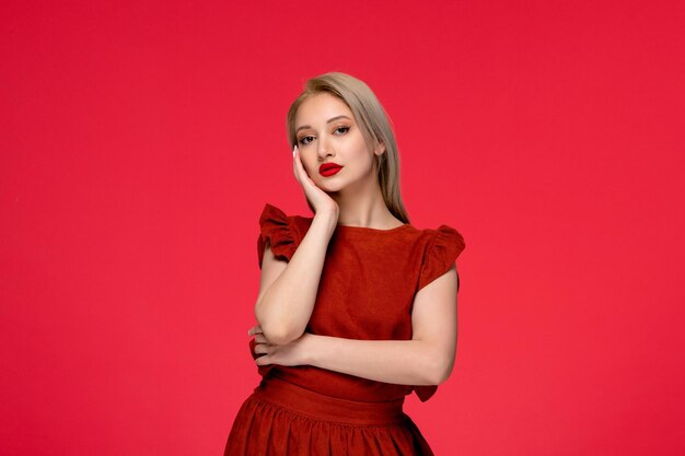 Red dress pretty cute blonde girl wearing burgundy dress with lipstick touching face