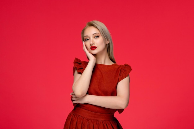 Red dress pretty cute blonde girl wearing burgundy dress with lipstick touching face