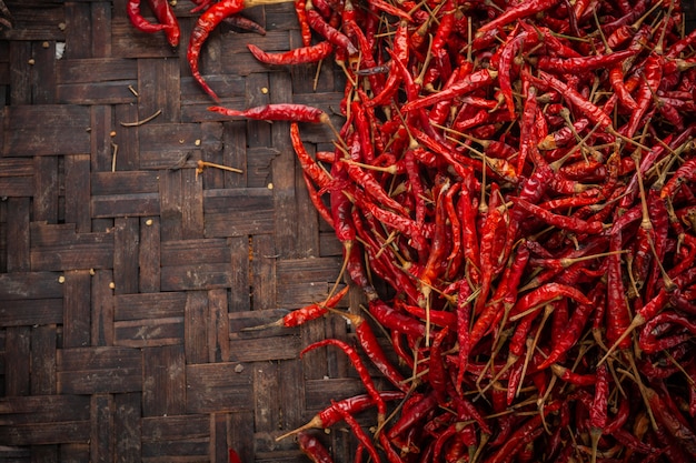 Red dried chilies placed on the space on the weave.