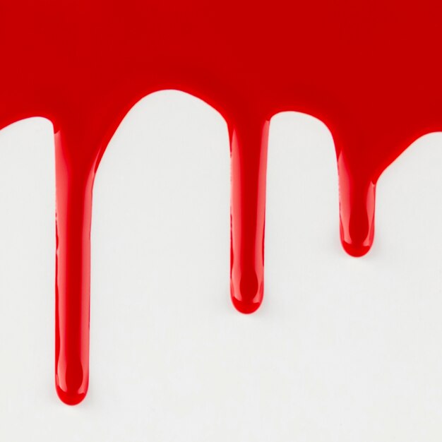 Red dripping paint on white background