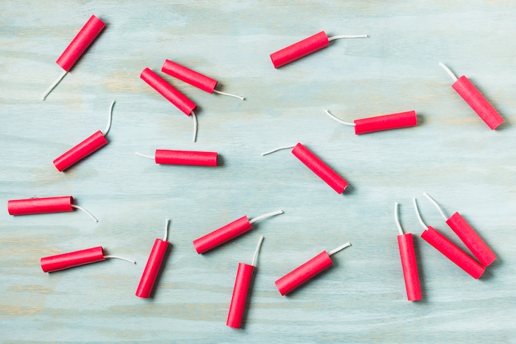 Free Photo red dynamite firecrackers on blue wooden textured background