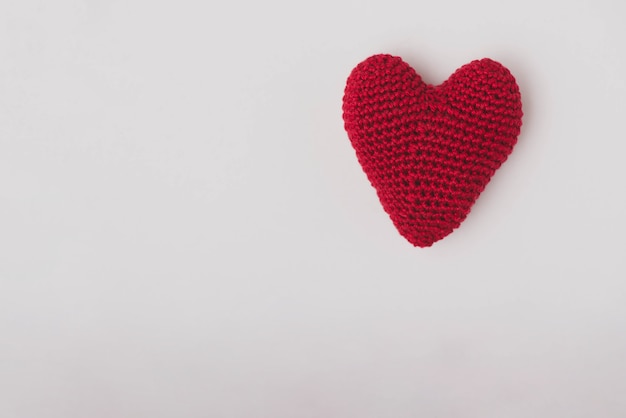 Red fabric heart on a white background