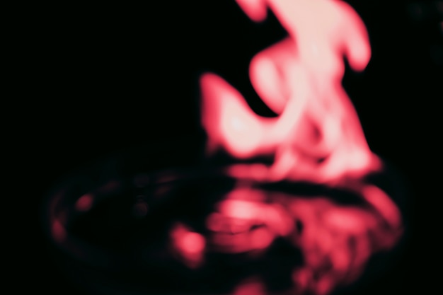 Red fire flame on blur black background
