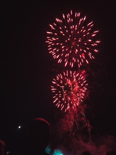 Red fireworks on night sky