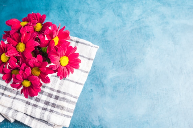 Red flowers bouquet on cloth 