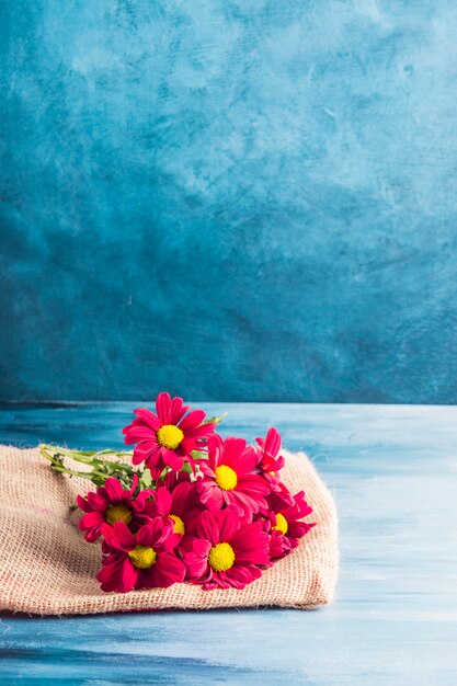 Red flowers on canvas on table