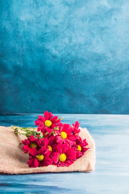 Red flowers on canvas on table