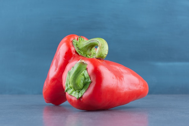 Red fresh peppers on marble.