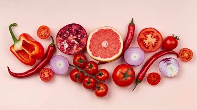 Red fruits and vegetables arrangement above view