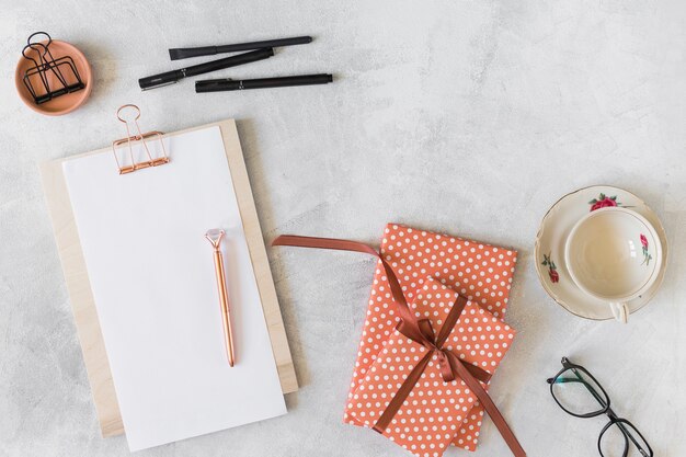 Red gift boxes, eyeglasses, clipboard and pens