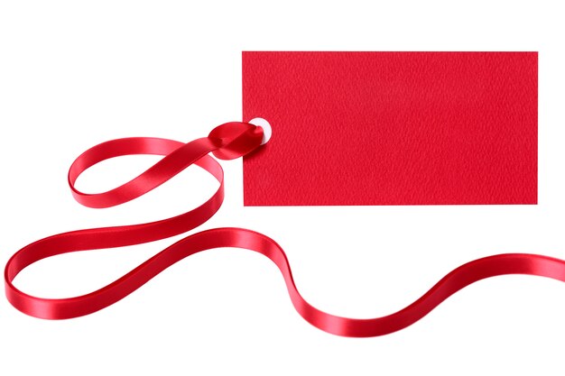 Red gift tag or label with ribbon isolated on white background