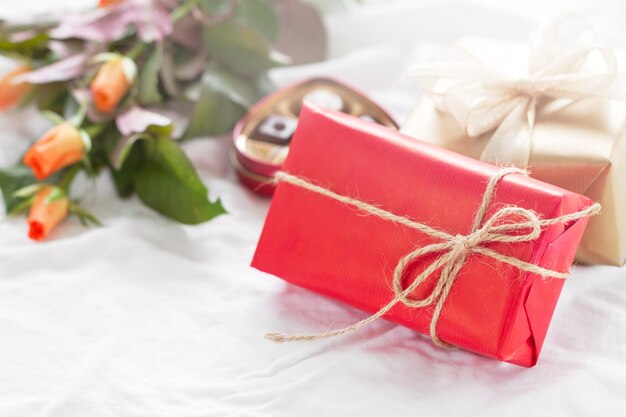 Red gift with flowers beside