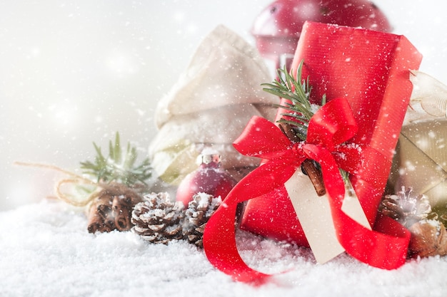 Red gift with holiday decoration and pine cones