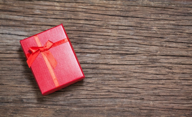 Red gift on wooden table