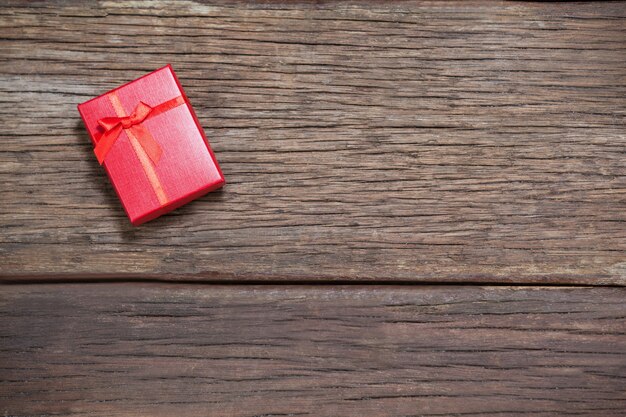 Red gift on wooden table